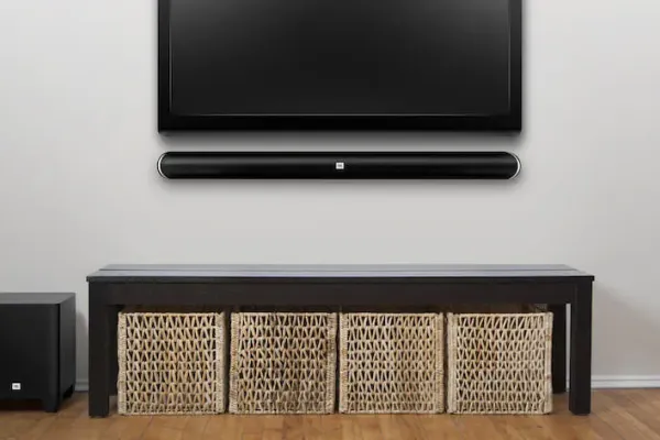 Wall mounted TV and soundbar above a low media console after a finished install